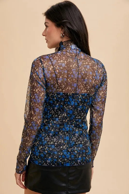 Black and blue floral sheer mesh top with lettuce hem from Annie Wear by Trendsi, featuring lightweight, breathable fabric and floral pattern.