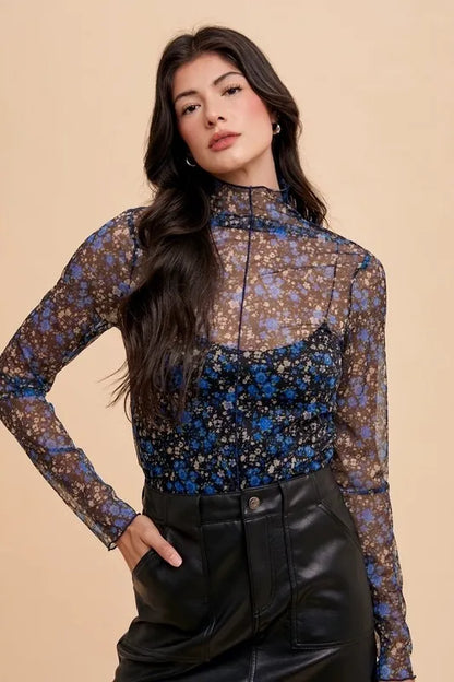 Black and blue floral sheer mesh top by Annie Wear with lettuce hem, featuring a lightweight, breathable design.
