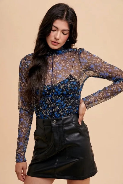 Black and blue floral sheer mesh top with lettuce hem from Annie Wear by Trendsi, featuring a lightweight, stylish design.
