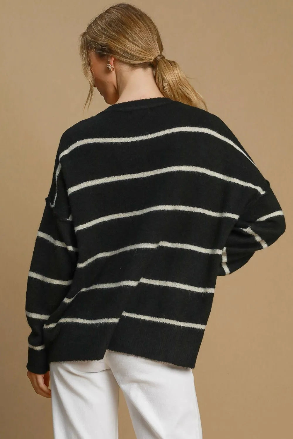 Black and cream striped wool blend sweater with round neckline by Umgee, styled with long sleeves.