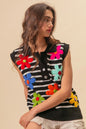 Black and ivory striped sweater vest with floral patch details and half-button front by Trendsi.