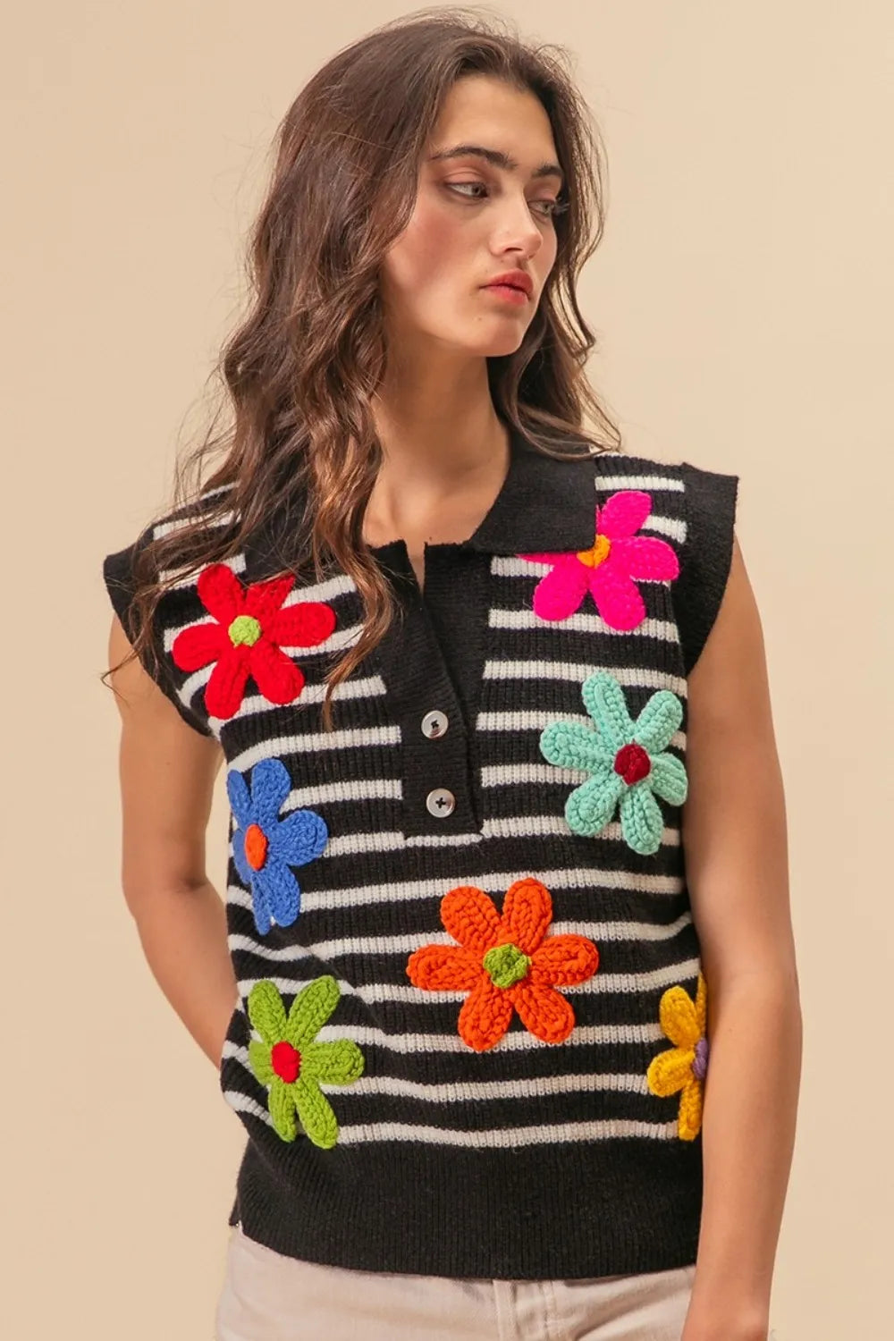 Black and ivory striped sweater vest with floral patch details and half-button front, by Trendsi.
