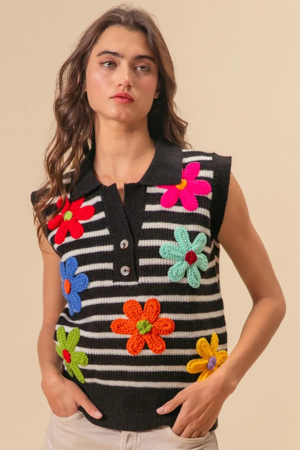 Black and ivory striped BiBi Flower Patch sweater vest with half buttons, featuring floral patches and a stylish, casual design.