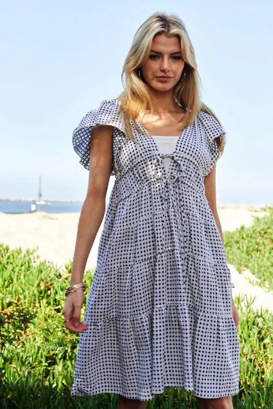 Black and ivory Davi & Dani jacquard V-neck flutter cap sleeve tiered dress, stylish and elegant for any occasion.
