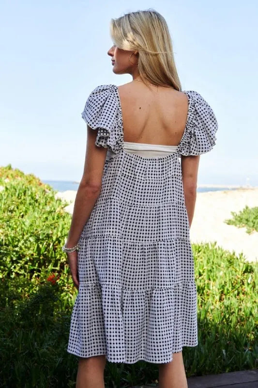 Black and ivory Davi & Dani Jacquard V-Neck Flutter Cap Sleeve Tiered Dress with a stylish tiered design and elegant V-neck.