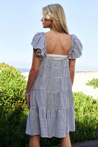 Black and ivory Davi & Dani Jacquard V-Neck Flutter Cap Sleeve Tiered Dress with a stylish tiered design and elegant V-neck.
