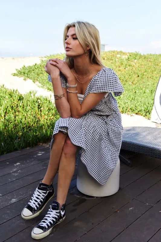 Black and ivory Davi & Dani Jacquard V-Neck Flutter Cap Sleeve Tiered Dress shown with tiered skirt and elegant V-neck design.