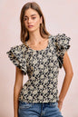 Black and light grey BiBi Floral Jacquard knit top with ruffle sleeves from Trendsi, featuring a stylish floral pattern.