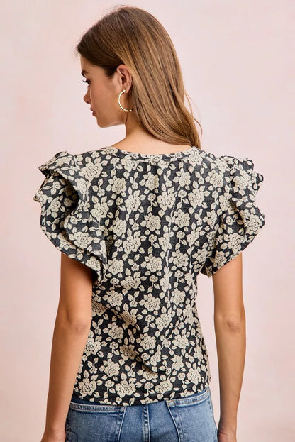 Black and light grey BiBi Floral Jacquard Knit Top with ruffle sleeves from Trendsi, showcasing intricate floral patterns and knit texture.