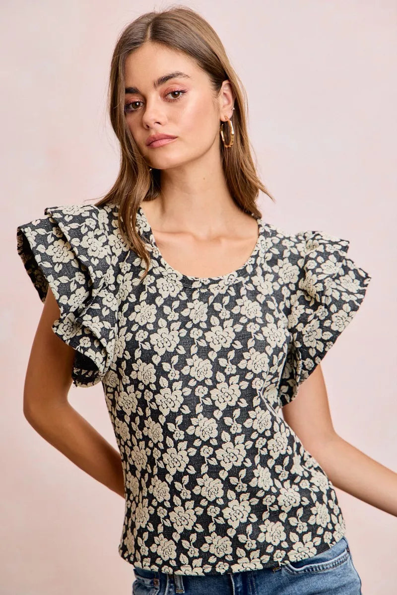 Black BiBi floral jacquard knit top with ruffle sleeves from Trendsi, featuring intricate floral patterns and a stylish knit design.
