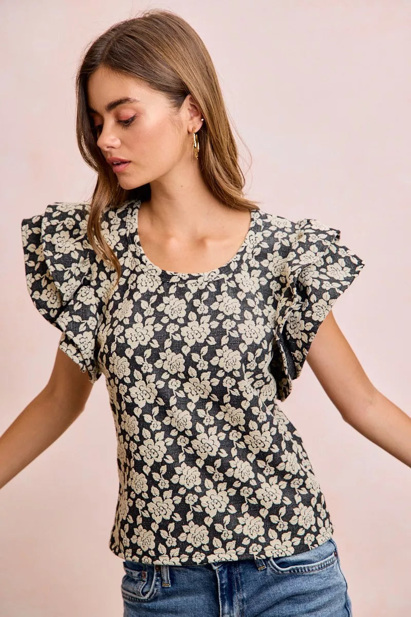 Black and light grey BiBi floral jacquard knit top with ruffle sleeves from Trendsi, detailed floral pattern and soft fabric.