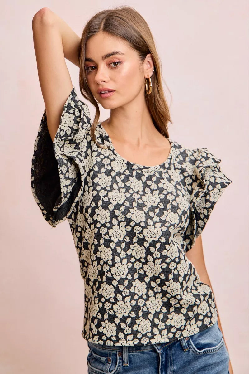 Black and light grey BiBi Floral Jacquard Knit Top with ruffle sleeves from Trendsi, featuring a stylish floral pattern.