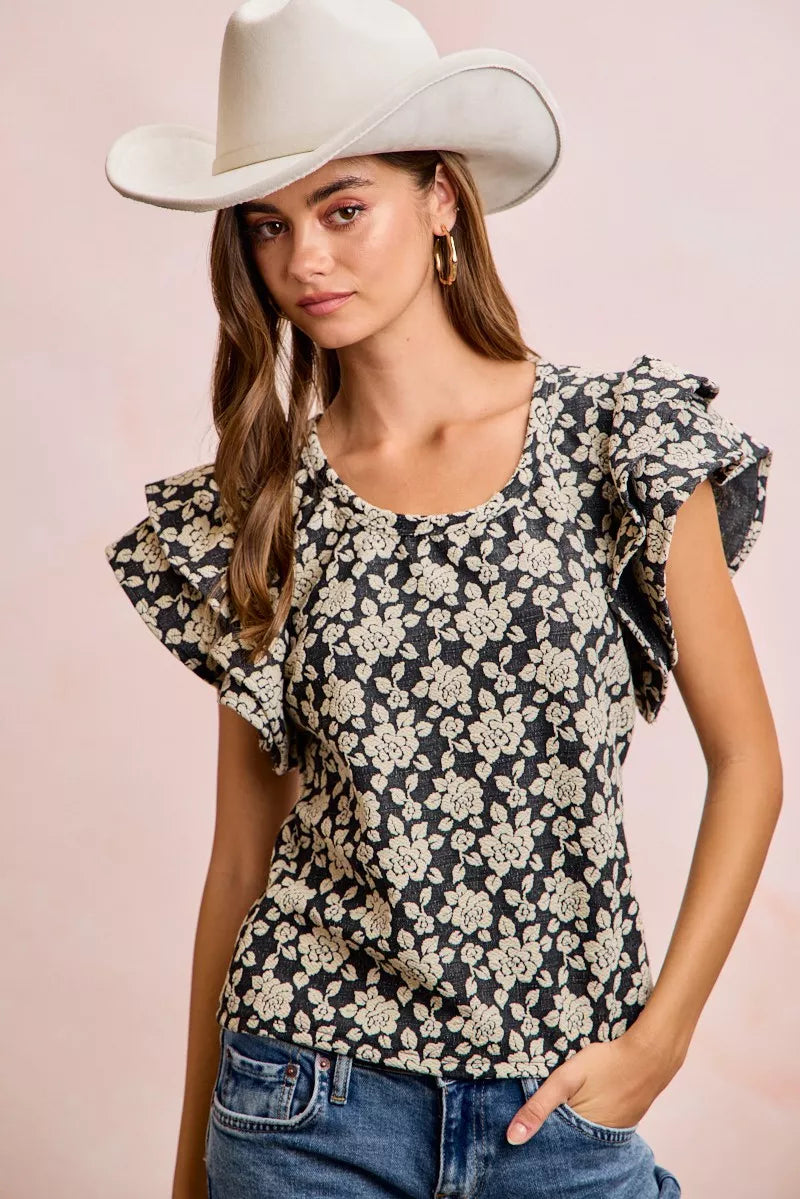 Black and light grey BiBi floral jacquard knit top with ruffle sleeves from Trendsi, showcasing detailed floral pattern and stylish design.
