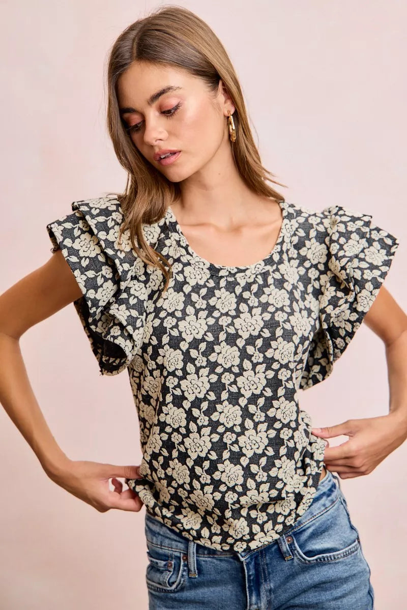 Black BiBi Floral Jacquard Knit Top with Ruffle Sleeves from Trendsi, featuring textured floral pattern and stylish ruffle details.