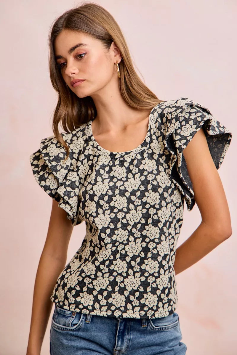 Black and light grey BiBi floral jacquard knit top with ruffle sleeves from Trendsi, showcasing intricate floral patterns and soft fabric.