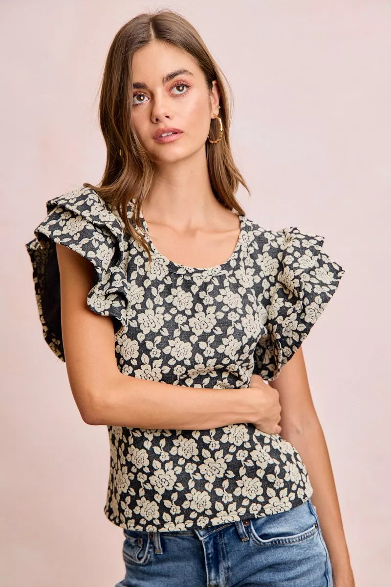 Black and light grey floral jacquard knit top with ruffle sleeves from Trendsi, featuring a stylish and cozy design.