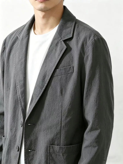 Plus size men's black button-up long sleeve blazer by Trendsi, shown on a mannequin with a tailored fit and classic lapel.