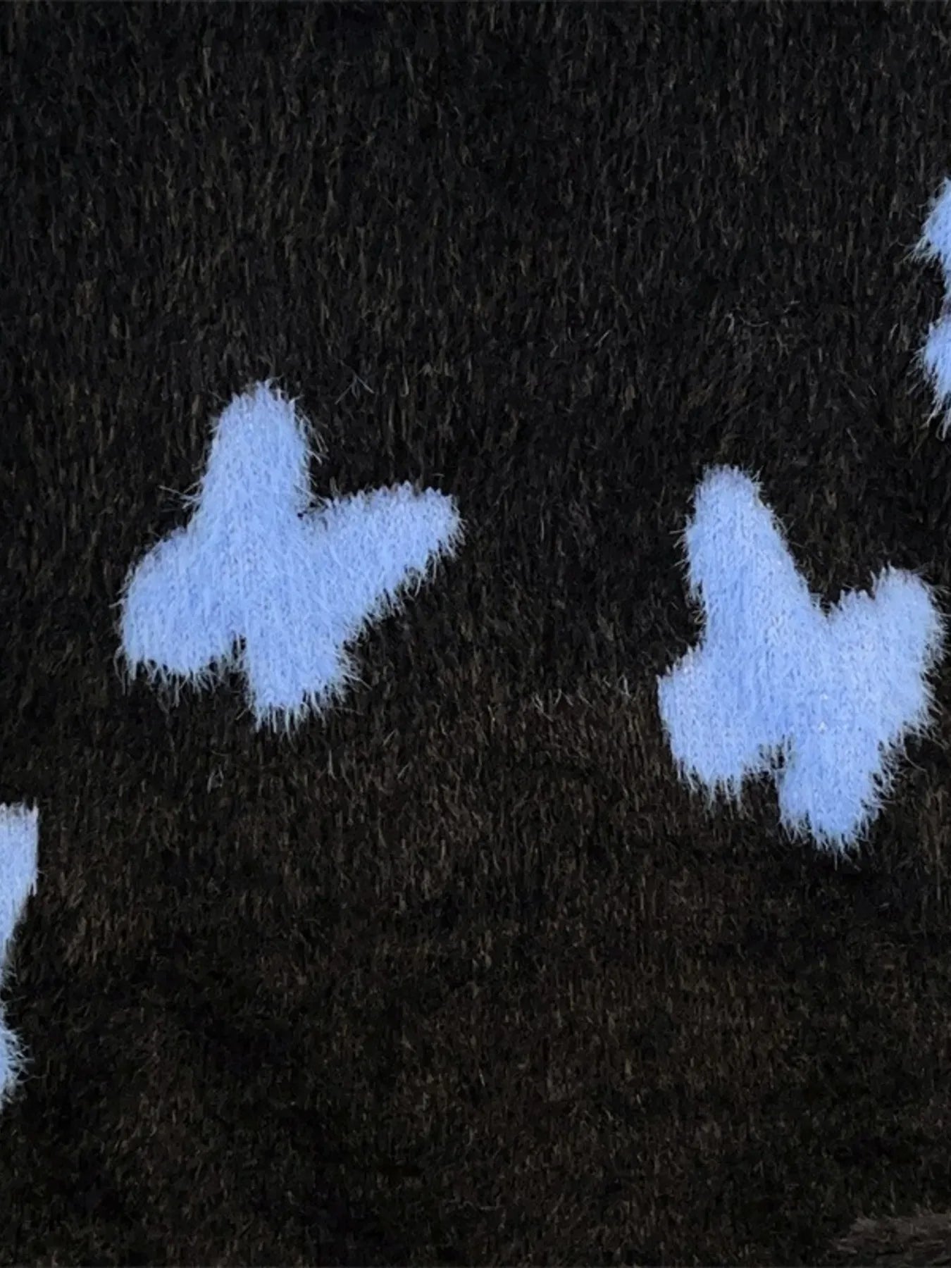 Plus size men's black fluffy butterfly round neck sweater from Trendsi, featuring a cozy, soft texture and casual fit.