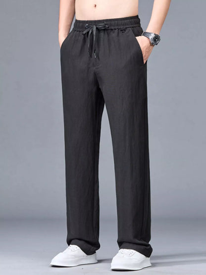 Men's plus size lightweight casual pants in black from Trendsi, made for comfort and style, shown on a model.