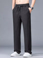 Men's plus size lightweight casual pants in black from Trendsi, made for comfort and style, shown on a model.