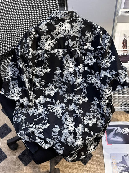 Men's plus size printed button-up short sleeve shirt by Trendsi, black with colorful abstract pattern, lightweight and casual fit.