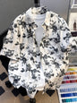 Plus size men's printed short sleeve button-up shirt by Trendsi, black fabric with colorful pattern, casual summer style.