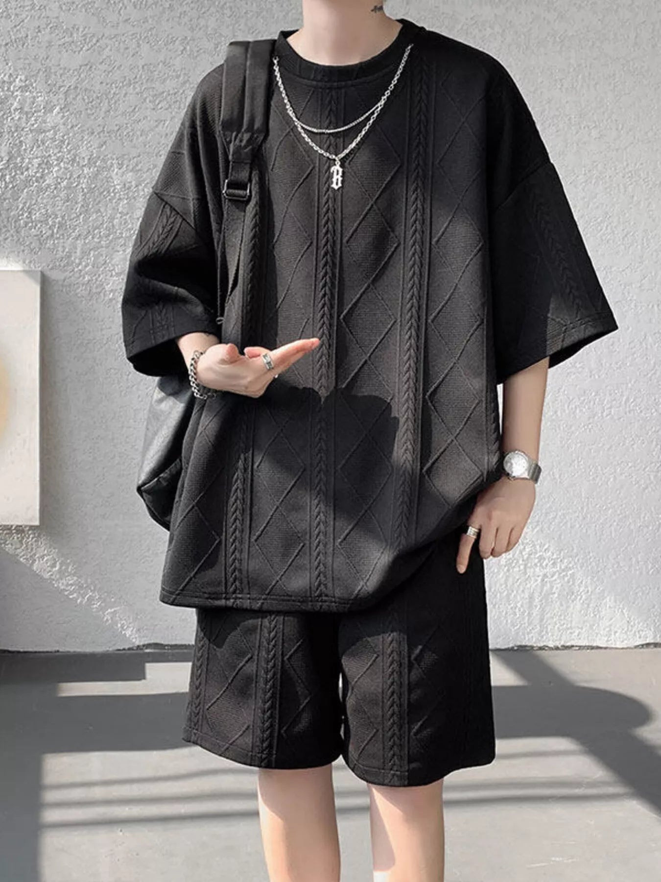 Men's plus size textured relaxed fit top and shorts set in black, casual summer outfit from Trendsi.