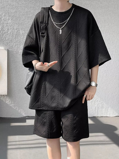 Men's plus size textured relaxed fit top and shorts set in black, casual summer outfit from Trendsi.