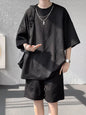 Men's plus size textured relaxed fit top and shorts set in black, casual summer outfit from Trendsi.