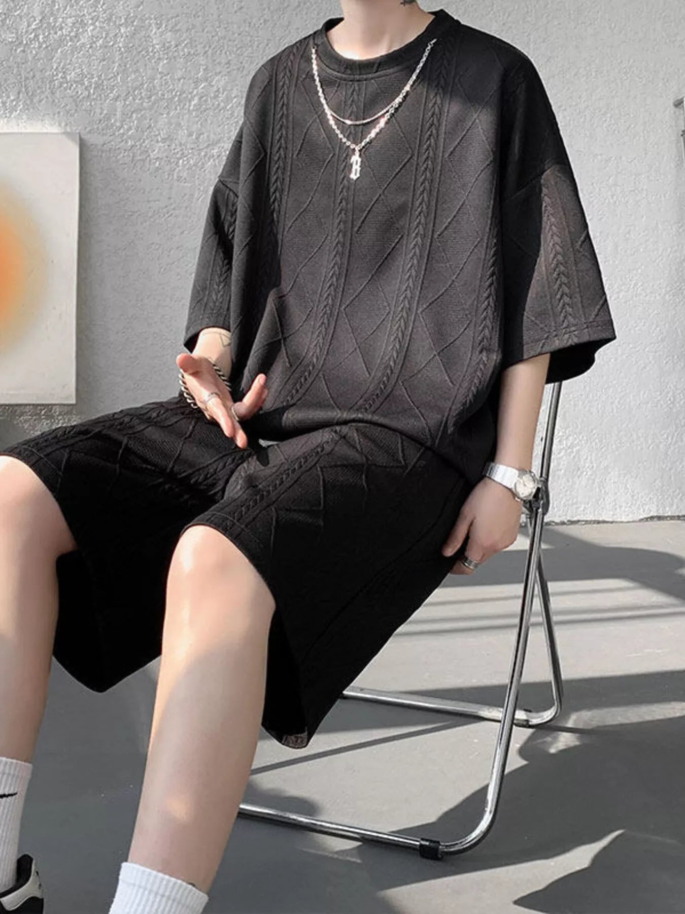 Men's plus size textured relaxed fit top and shorts set in black, casual summer outfit by Trendsi.