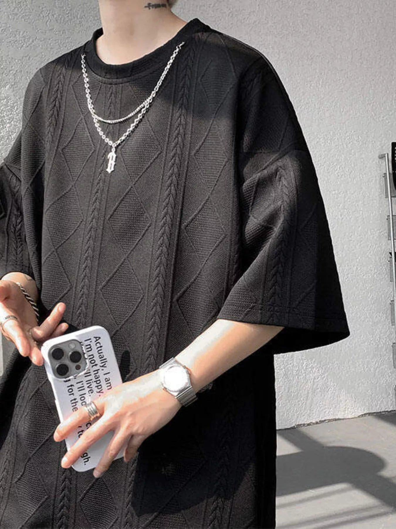 Black men's plus size textured relaxed fit top and shorts set by Trendsi, featuring comfortable casual style.