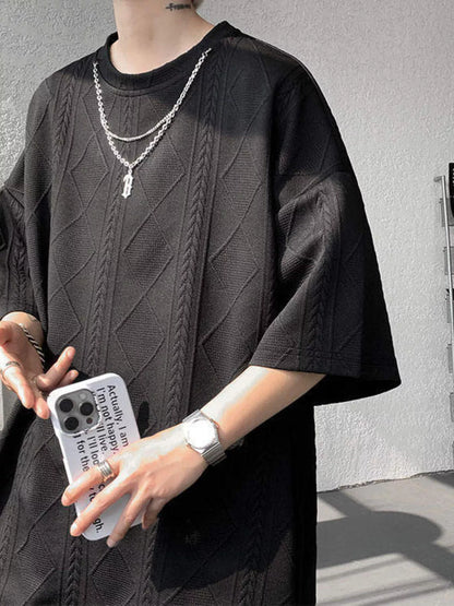 Black men's plus size textured relaxed fit top and shorts set by Trendsi, featuring comfortable casual style.