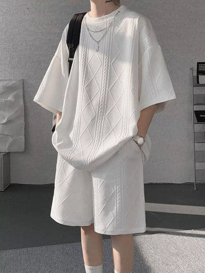 Men's plus size black textured relaxed fit top and shorts set by Trendsi, featuring a comfortable casual style.