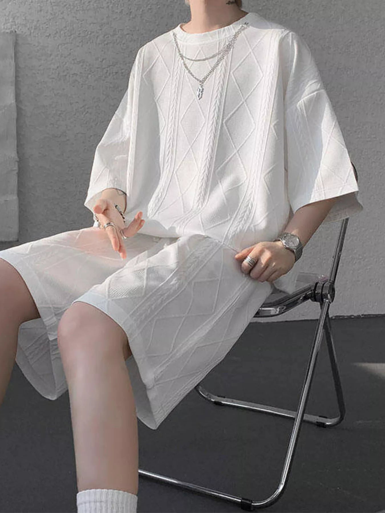 Men's plus size black textured relaxed fit top and shorts set by Trendsi, shown on a model with casual styling.