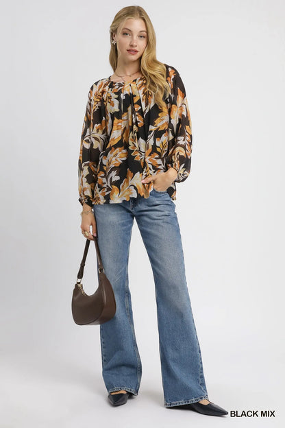 Black Umgee balloon sleeve blouse with autumn leaf print and relaxed fit, featuring stylish balloon sleeves.