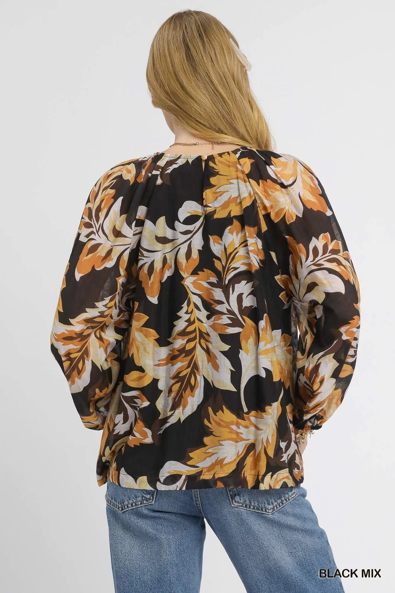 Black Umgee autumn leaf print balloon sleeve blouse with ruffled details, featuring a relaxed fit and stylish design.