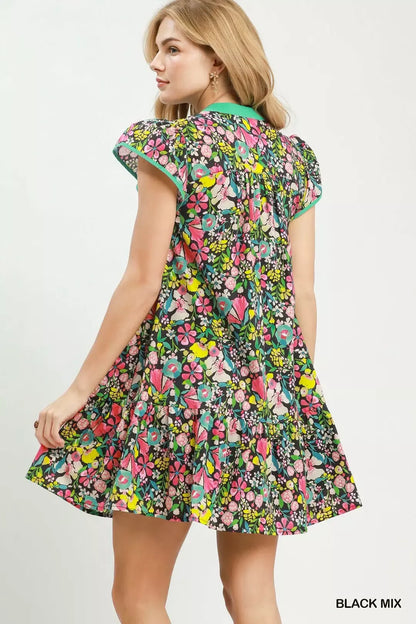 Black floral Umgee tiered mini dress with flutter sleeves, featuring a feminine, tiered design and lightweight fabric.