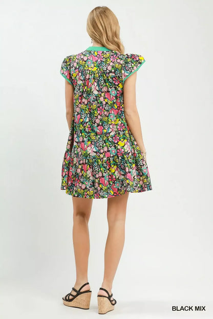 Black floral Umgee tiered mini dress with flutter sleeves, showcasing a stylish and feminine design.