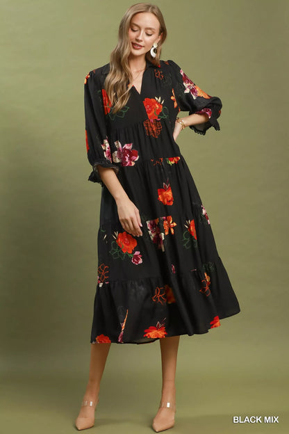 Black floral print tiered midi dress with puff sleeves by Umgee, featuring a feminine, flowy silhouette and detailed floral pattern.