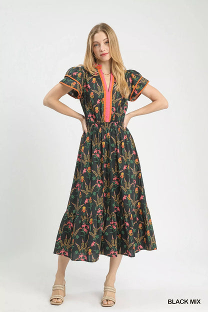 Black Umgee Mix Floral Midi Dress by Trendsi featuring a flowy design and floral pattern, shown on a model.