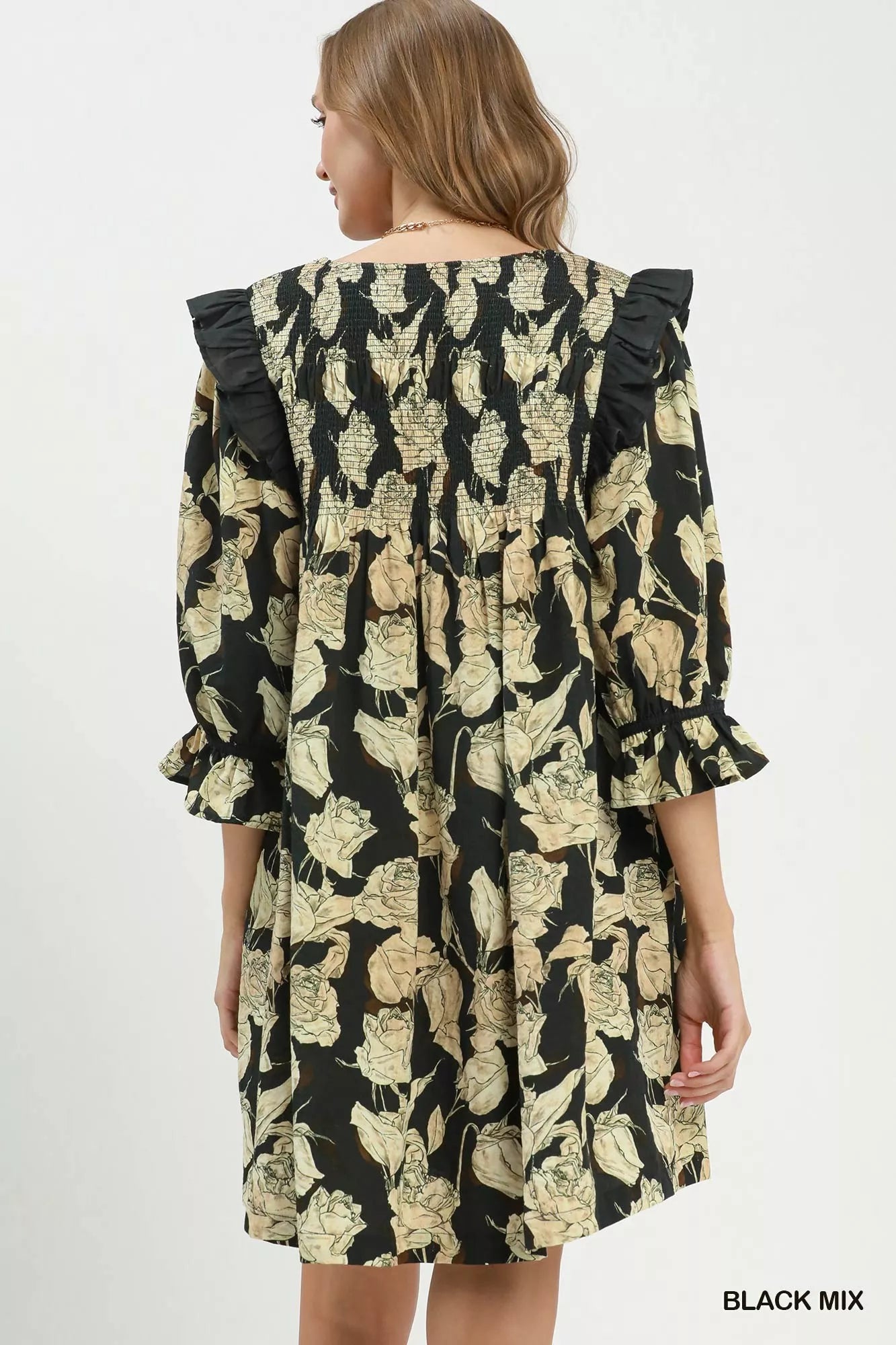 Black floral print flowy dress by Umgee with smocked bodice and ruffle details, featuring a relaxed, feminine silhouette.