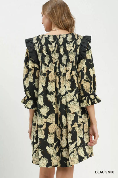 Black floral print flowy dress by Umgee with smocked bodice and ruffle details, featuring a relaxed, feminine silhouette.