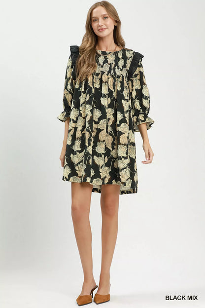Black floral print flowy dress by Umgee with smocked bodice and ruffle details, featuring a relaxed, breezy silhouette.