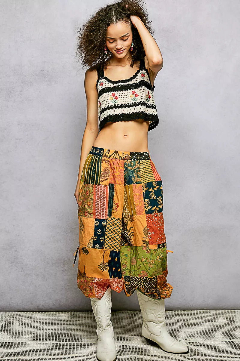 Black floral embroidered cropped crochet cami with scalloped hem, trendy women's top with intricate embroidery and delicate scalloped edges.