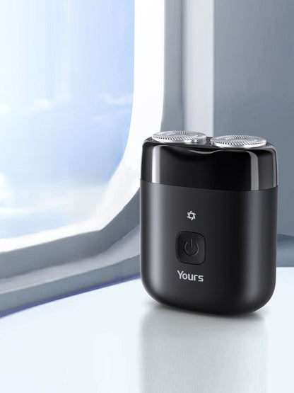 Black portable mini electric shaver by Trendsi, compact design ideal for travel and quick grooming.