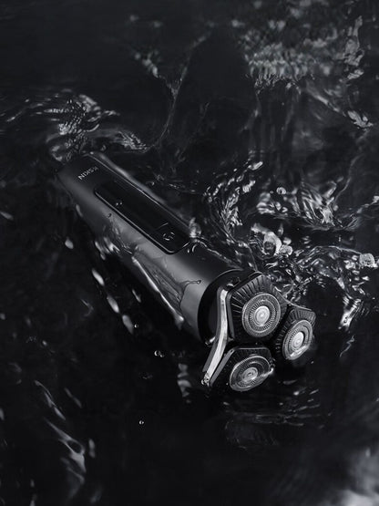Black 3D rotary electric shaver with LED display, featuring multiple rotary blades for a close, comfortable shave.