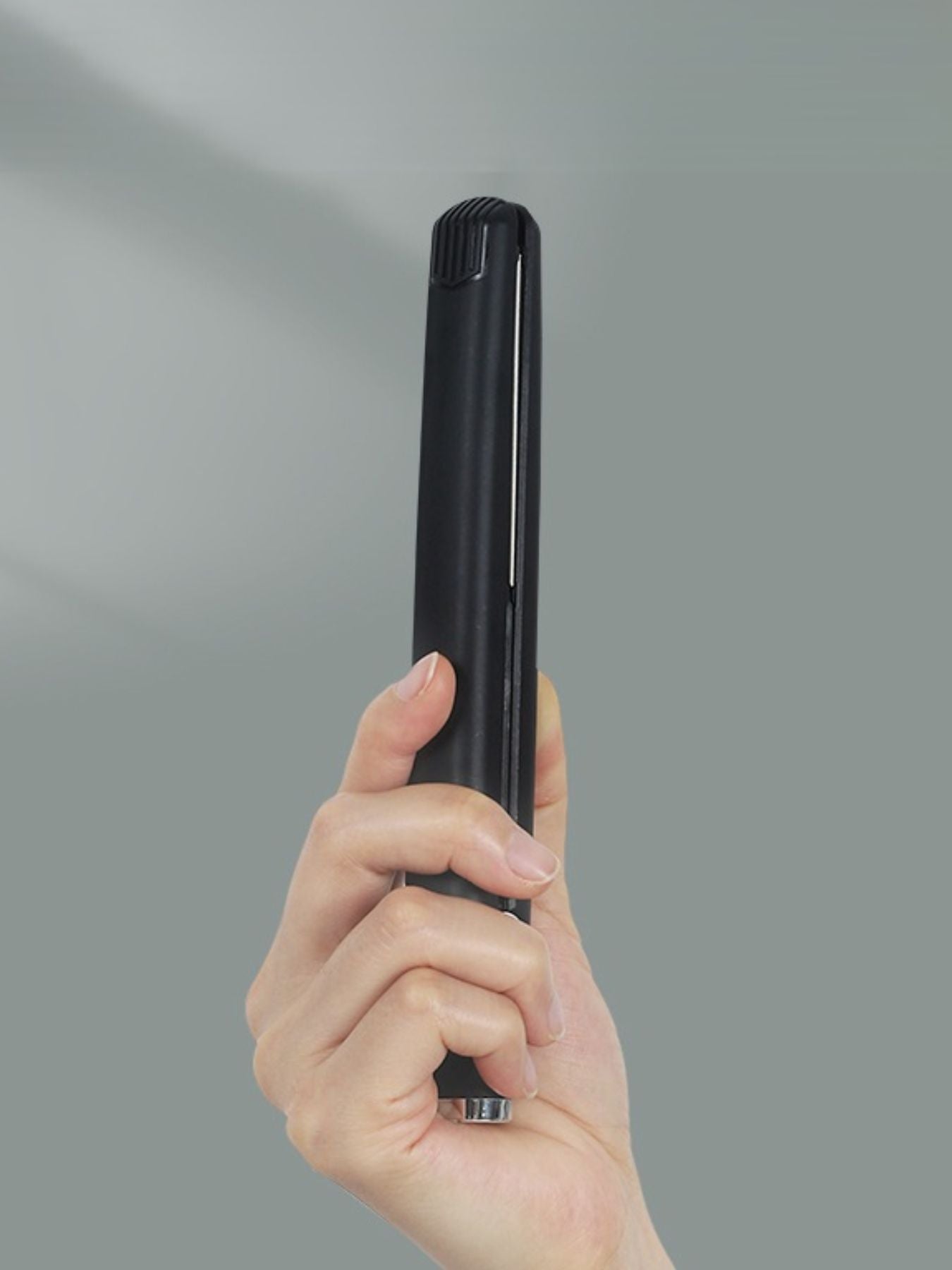 Black ceramic hair straightener from Trendsi with sleek design and ceramic plates for smooth, styled hair.