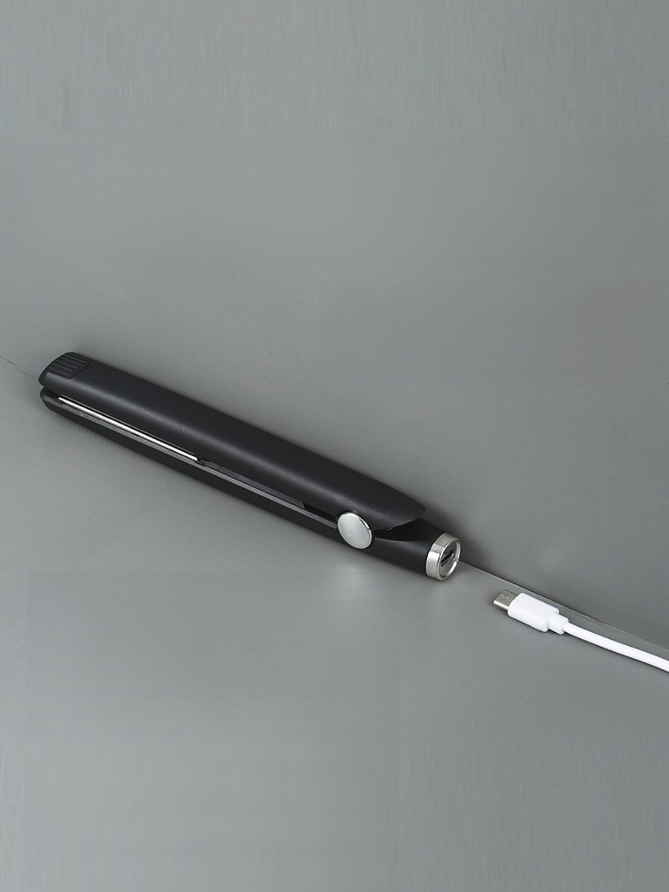 Black ceramic hair straightener from Trendsi, featuring a sleek design and ceramic plates for smooth, frizz-free styling.