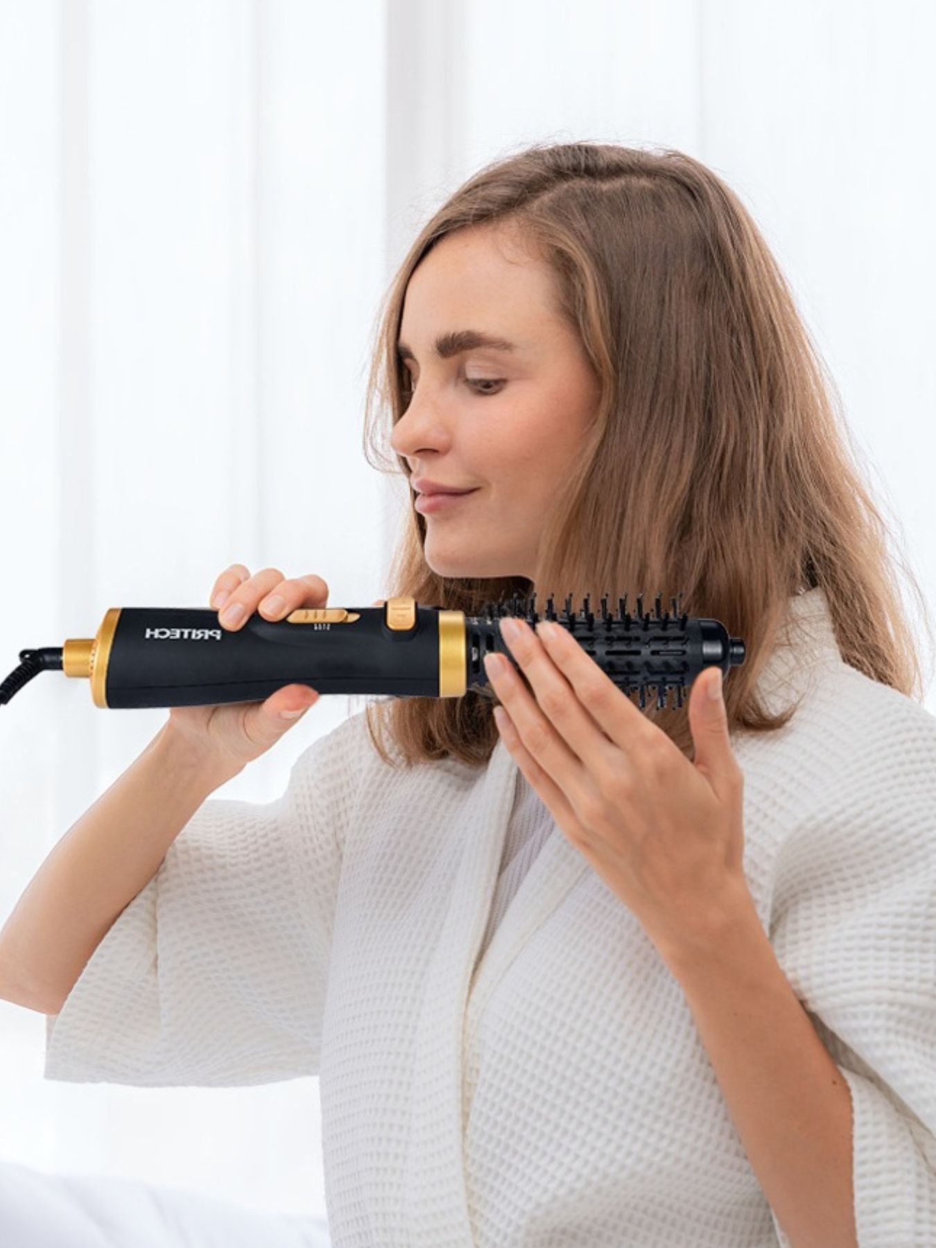Black Trendsi fast heating hot air brush with one-size design, shown in use for smooth, voluminous hair styling.