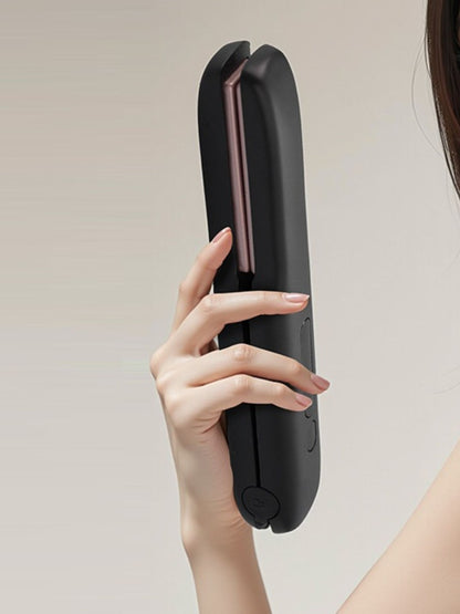 Black portable cordless hair straightener by Trendsi, compact design with ceramic plates for quick styling on the go.